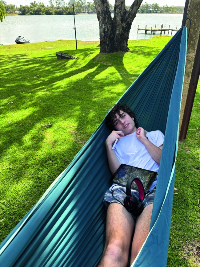 Cruz relaxing in a hammock by the water